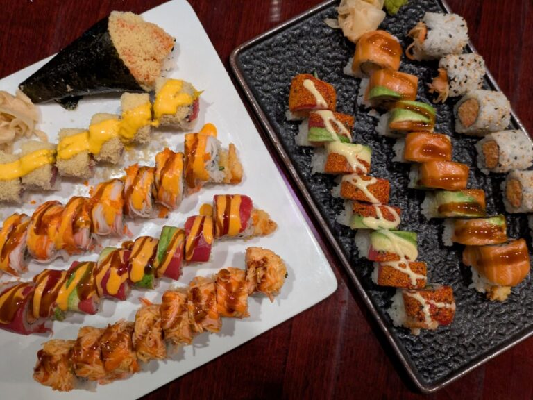 Family gathering around trays of sushi